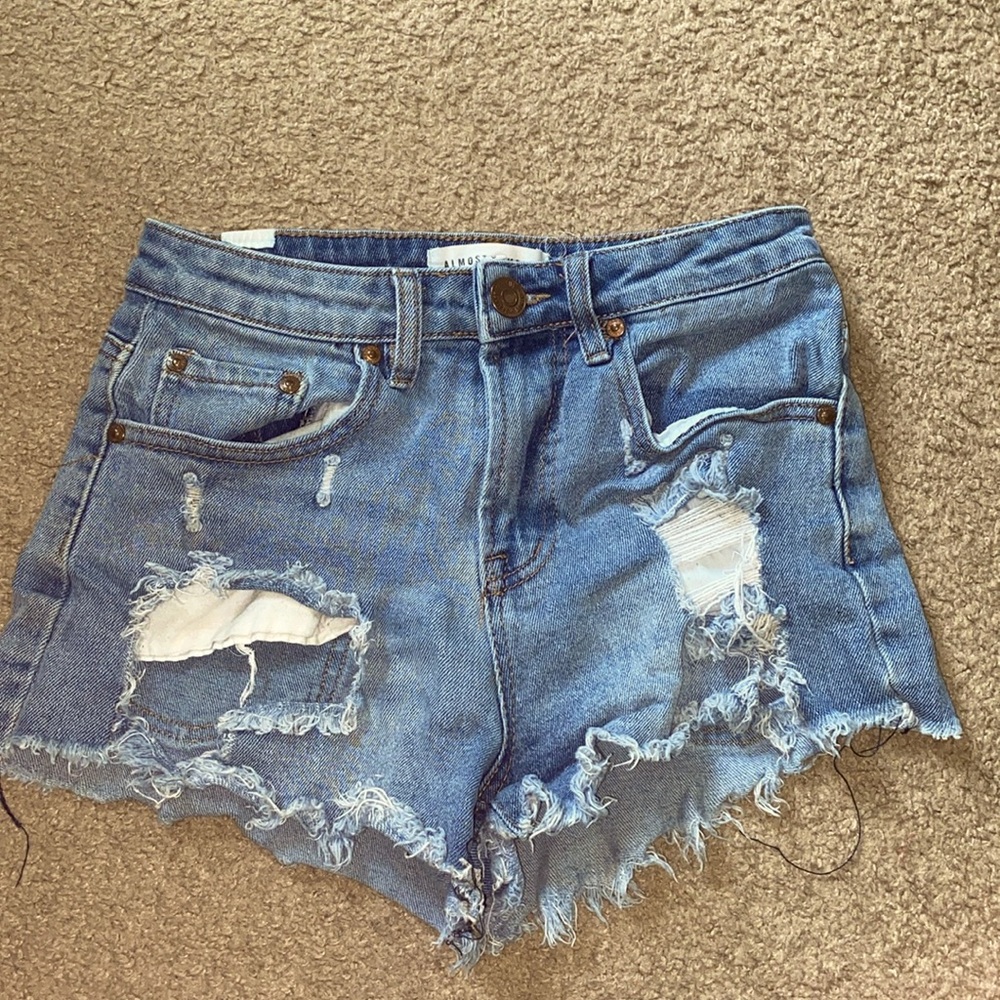 medium washed ripped women’s jeans shorts